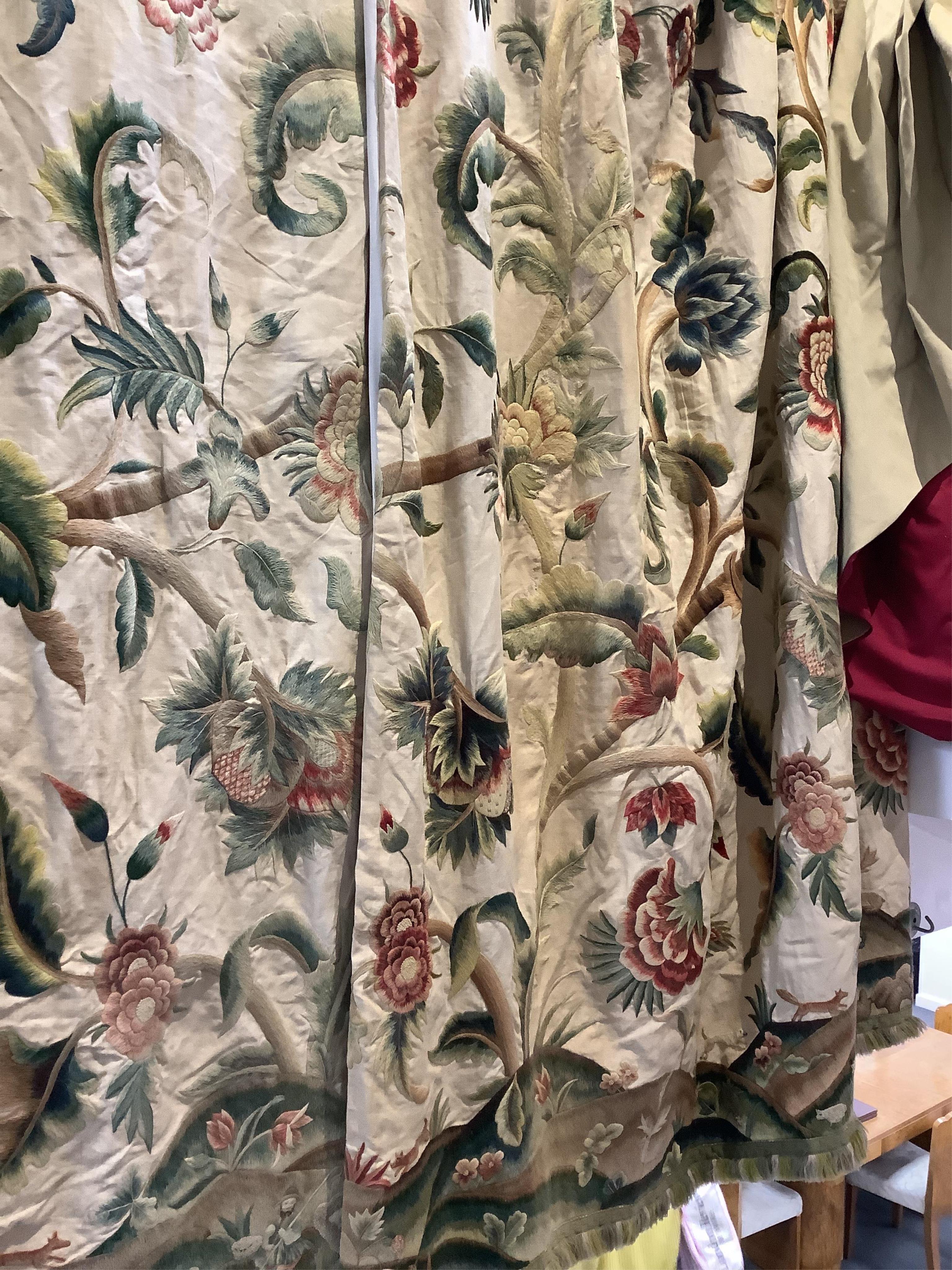 Six 20th century crewel work ‘Tree of Life’ cream linen curtains. Worked at the base in coloured wools depicting a pastoral scene of a shepherd playing a flute amongst sheep, deer, squirrels and flowers with a dog chasin